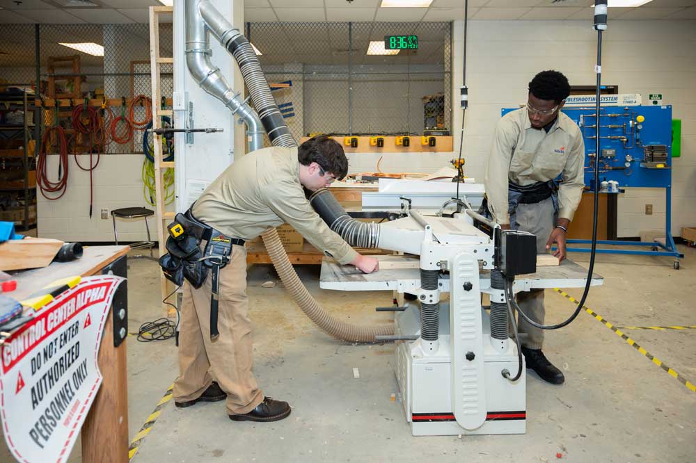 Students working on a machine.