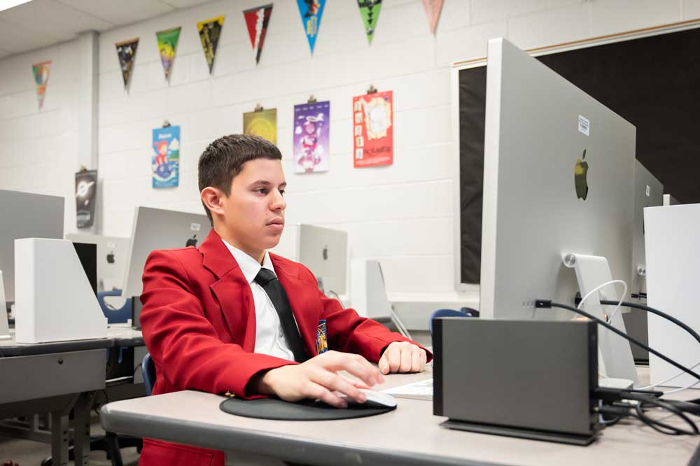 A student works at a computer.