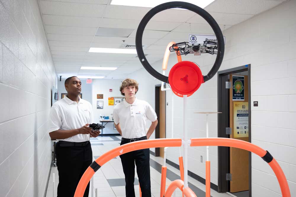 Two students working with a drone.